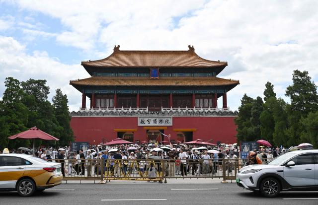 People visit the Forbidden city in Beijing on August 13, 2026. (Photo by Adek BERRY / AFP)