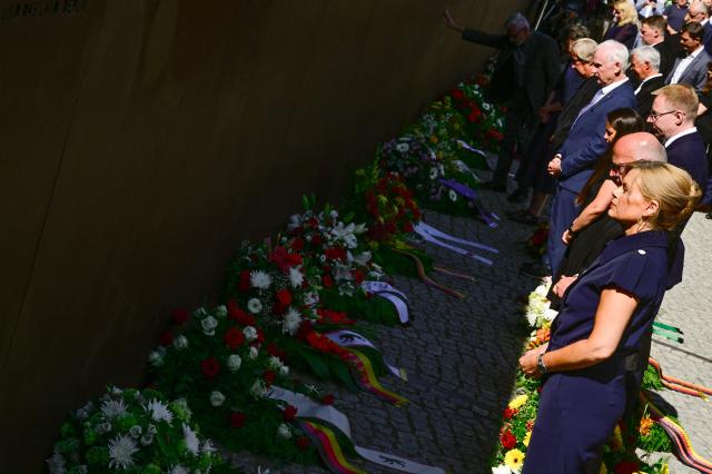 President of the Bundestag Julia Kloeckner (front) and Berlin's mayor Kai Wegner attend the Central Commemorative Ceremony of the State of Berlin and the Federal Government on the 65th Anniversary of the Construction of the Berlin Wall on August 13, 2026. (Photo by John MACDOUGALL / AFP)