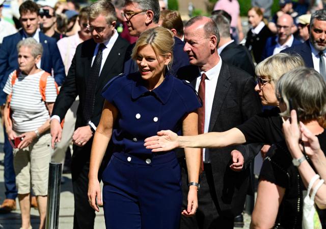 President of the Bundestag Julia Kloeckner and director of the Berlin Wall Foundation Axel Klausmeier arrive for the Central Commemorative Ceremony of the State of Berlin and the Federal Government on the 65th Anniversary of the Construction of the Berlin Wall on August 13, 2026. (Photo by John MACDOUGALL / AFP)