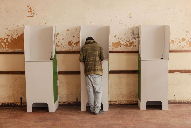 A voter casts his ballot at a polling station in Lusaka on August 13, 2026. Zambians went to the polls on August 13 with economic hardship testing President Hakainde Hichilema's record as he seeks a second term to govern the copper-rich nation. Polling stations in the southern African nation opened at 6:00 am (0400 GMT) and were due to close 12 hours later, with 8.7 million voters registered to cast their ballots. (Photo by GIANLUIGI GUERCIA / AFP)