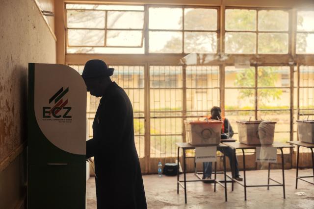 A voter casts his ballot at a polling station in Lusaka on August 13, 2026. Zambians went to the polls on August 13 with economic hardship testing President Hakainde Hichilema's record as he seeks a second term to govern the copper-rich nation. Polling stations in the southern African nation opened at 6:00 am (0400 GMT) and were due to close 12 hours later, with 8.7 million voters registered to cast their ballots. (Photo by GIANLUIGI GUERCIA / AFP)