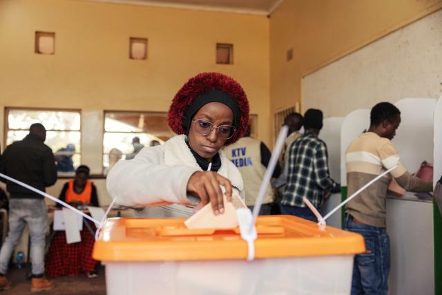 A woman casts her ballot at a polling station in Lusaka on August 13, 2026. Zambians went to the polls on August 13 with economic hardship testing President Hakainde Hichilema's record as he seeks a second term to govern the copper-rich nation. Polling stations in the southern African nation opened at 6:00 am (0400 GMT) and were due to close 12 hours later, with 8.7 million voters registered to cast their ballots. (Photo by GIANLUIGI GUERCIA / AFP)