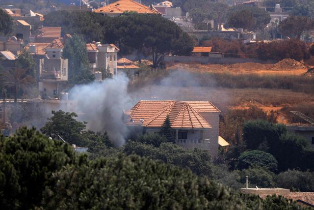 This picture taken from the southern Lebanese village of Zawtar al-Gharbiyah shows smoke billowing from a house in the Israeli-controlled nearby village of Zawtar al-Charkiyah on August 13, 2026. Lebanese Prime Minister Nawaf Salam on August 12 condemned Israel's "systematic destruction" in the country's south as a violation of international law, as Israel's defence minister said its military was "destroying all the houses" there. (Photo by Ammar Ammar / AFP) / 