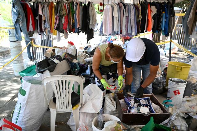 Earthquake victims look for recovered personal belongings in Cali, Colombia, on August 13, 2026, three days after a 7.4 earthquake. Rescuers in Colombia were making last-ditch efforts to locate earthquake survivors early on August 13, 2026, as the critical 72-hour window for rescue operations neared its end. (Photo by Raul ARBOLEDA / AFP)