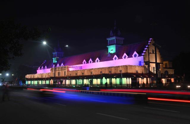 A building is seen illuminated on the eve of Pakistan's Independence Day celebrations in Lahore on August 13, 2026. (Photo by Arif ALI / AFP)