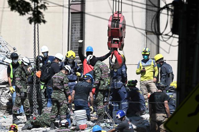 Rescuers search for survivors amid the rubble of a collapsed building in Cali, Colombia, on August 13, 2026, three days after a 7.4 earthquake. Rescuers in Colombia were making last-ditch efforts to locate earthquake survivors early on August 13, 2026, as the critical 72-hour window for rescue operations neared its end. (Photo by Joaquin SARMIENTO / AFP)