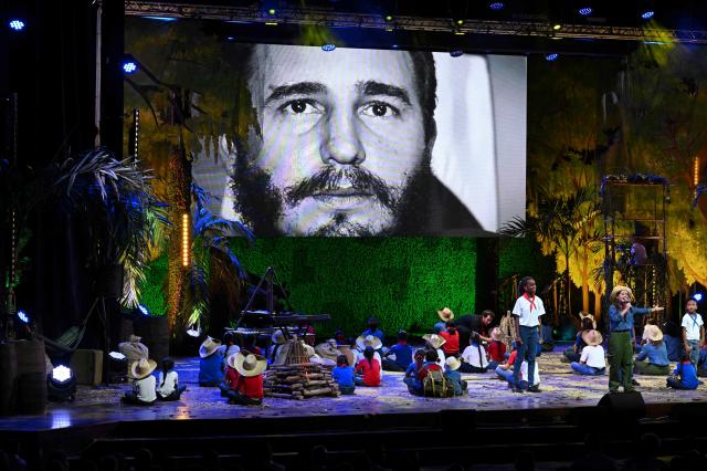 An image of the late leader Fidel Castro is projected during a gala commemorating the 100th anniversary of his birth at the Karl Marx Theatre in Havana, on August 13, 2026. The 95-year-old and US-indicted Cuban leader Raul Castro received a standing ovation as he appeared in public for the first time in months on August 13, 2026, attending an event in Havana to mark the centenary of his brother Fidel's birth. (Photo by YAMIL LAGE / AFP)