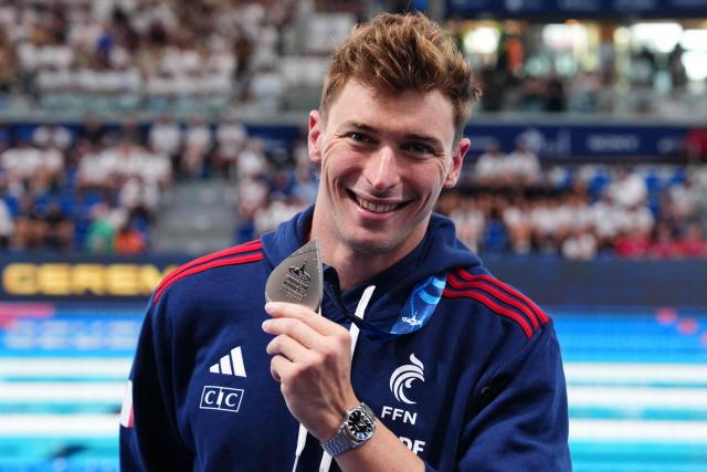 France's Maxime Grousset poses with his silver medal on the podium of the men's 100m butterfly swimming event during the LEN European Aquatics Championships at the Olympic Aquatic Centre in Saint-Denis, northern suburbs of Paris, on August 13, 2026. (Photo by Dimitar DILKOFF / AFP)