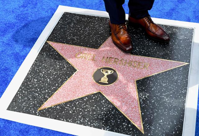 US former professional baseball pitcher and sports broadcast analyst Orel Hershiser (detail of shoes) stands on his newly unveiled Hollywood Walk of Fame star during his ceremony in the Hollywood neighborhood of Los Angeles, California, on August 13, 2026. (Photo by Katie FLORES / AFP)