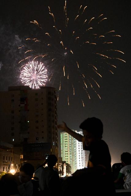 A boy watches a firework explode during celebrations ahead of Pakistan's 79th anniversary of Independence Day in Karachi on August 14, 2026. (Photo by Rizwan TABASSUM / AFP)