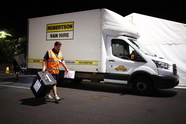 The first ballot box is carried into the count centre venue for the by-election of the parliamentary seat of Clacton, at Clacton Leisure Centre, eastern England on August 13, 2026. Voters in eastern England headed to the polls on August 13 for a by-election triggered by hard-right Reform UK leader Nigel Farage. (Photo by Henry NICHOLLS / AFP)