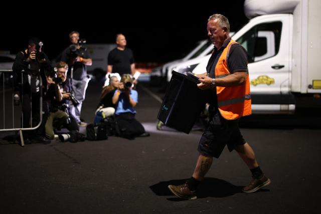 A ballot box is carried into the count centre venue for the by-election of the parliamentary seat of Clacton, at Clacton Leisure Centre, eastern England on August 13, 2026. Voters in eastern England headed to the polls on August 13 for a by-election triggered by hard-right Reform UK leader Nigel Farage. (Photo by Henry Nicholls / AFP)