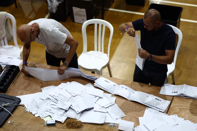 Ballots are sorted before being counted at the count centre venue for the by-election of the parliamentary seat of Clacton, at Clacton Leisure Centre, eastern England on August 13, 2026. Voters in eastern England headed to the polls on August 13 for a by-election triggered by hard-right Reform UK leader Nigel Farage. (Photo by Henry NICHOLLS / AFP)