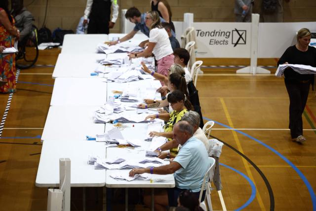 Ballots are counted at the count centre venue for the by-election of the parliamentary seat of Clacton, at Clacton Leisure Centre, eastern England on August 13, 2026. Voters in eastern England headed to the polls on August 13 for a by-election triggered by hard-right Reform UK leader Nigel Farage. (Photo by Henry NICHOLLS / AFP)