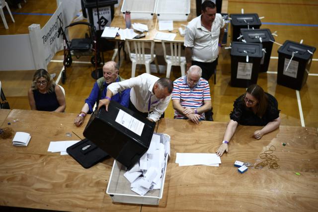 Ballots are sorted before being counted at the count centre venue for the by-election of the parliamentary seat of Clacton, at Clacton Leisure Centre, eastern England on August 13, 2026. Voters in eastern England headed to the polls on August 13 for a by-election triggered by hard-right Reform UK leader Nigel Farage. (Photo by Henry NICHOLLS / AFP)