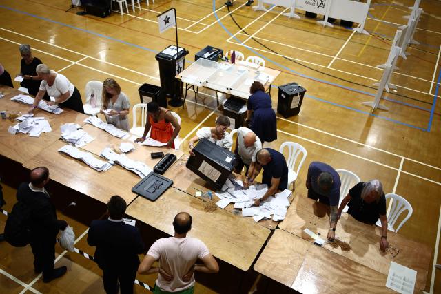 Ballots are sorted before being counted at the count centre venue for the by-election of the parliamentary seat of Clacton, at Clacton Leisure Centre, eastern England on August 13, 2026. Voters in eastern England headed to the polls on August 13 for a by-election triggered by hard-right Reform UK leader Nigel Farage. (Photo by Henry Nicholls / AFP)