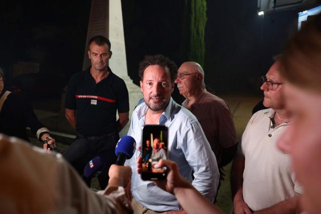 Gilles Clavreul, prefect of the Landes department, speaks to the press as a wildfire rages in the Landes forest in Luglon, southwestern France, on August 13, 2026. The fire that broke out on August 13, 2026 in the Landes forest has now spread across 400 hectares, and 400 people "are being evacuated as a precautionary measure", according to the prefecture of this south-western department. (Photo by ROMAIN PERROCHEAU / AFP)