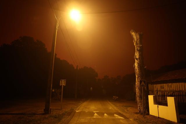 A wildfire rages in the Landes forest in Luglon, southwestern France, on August 13, 2026. The fire that broke out on August 13, 2026 in the Landes forest has now spread across 400 hectares, and 400 people "are being evacuated as a precautionary measure", according to the prefecture of this south-western department. (Photo by ROMAIN PERROCHEAU / AFP)