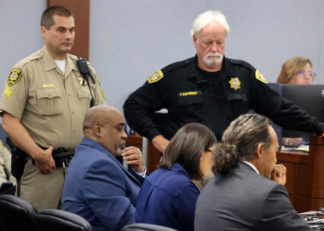 Duane Davis, seated left, appears in court with his attorney Michael Sanft, right, and Sanft's assistant Megan Hampton during the fourth day of jury selection in his murder trial, related to the 1996 killing of rapper Tupac Shakur, at Clark County District Court Regional Justice Center in Las Vegas, Nevada, on August 13, 2026. The trial of the former gang leader accused of orchestrating the murder of rapper Tupac Shakur finally began on August 10, 30 years after one of America's most high-profile unresolved killings. The proceedings, expected to last a month, will likely not make clear who fired the shots that killed the California hip-hop legend on the night of September 7, 1996, while he was in Las Vegas to see a Mike Tyson boxing match. (Photo by Bizuayeha TESFAYE / POOL / AFP)