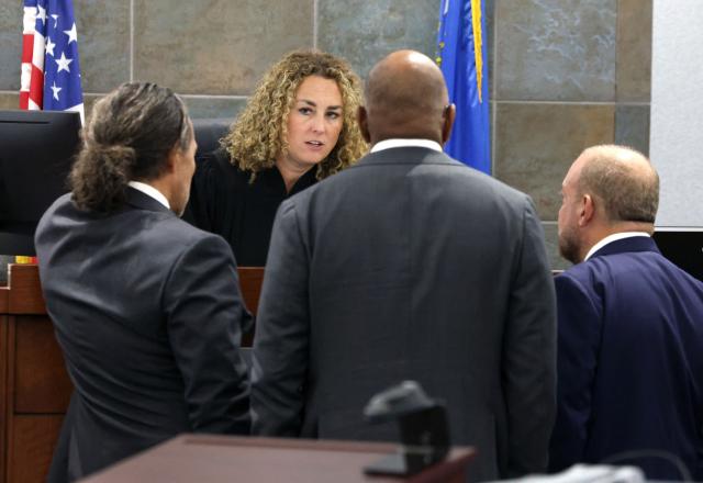 District Court Judge Carli Kierny talks with Duane Davis' attorney, Michael Sanft (L), Chief Deputy District Attorneys Binu Palal and Marc DiGiacomo (R), during a bench conference during the fourth day of jury selection in Davis' murder trial over the 1996 shooting death of rapper Tupac Shakur at the Regional Justice Center in Las Vegas, Nevada, on August 13, 2026. The trial of the former gang leader accused of orchestrating the murder of rapper Tupac Shakur finally began on August 10, 30 years after one of America's most high-profile unresolved killings. The proceedings, expected to last a month, will likely not make clear who fired the shots that killed the California hip-hop legend on the night of September 7, 1996, while he was in Las Vegas to see a Mike Tyson boxing match. (Photo by Bizuayeha TESFAYE / POOL / AFP)