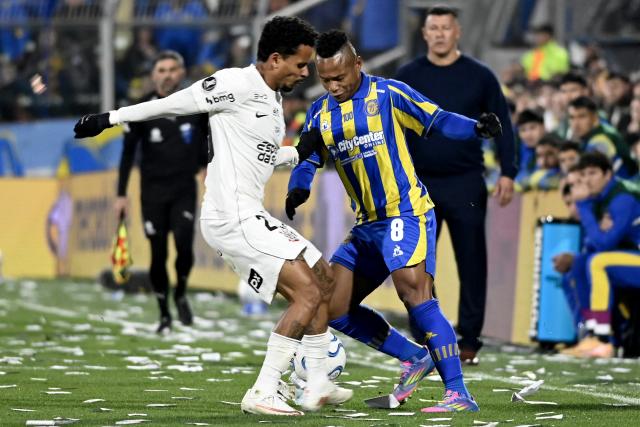 Corinthians' midfielder #29 Allan and Rosario Central's Colombian midfielder #08 Jaminton Campaz fight for the ball during the first leg of the Copa Libertadores round of 16 football match between Argentina's Rosario Central and Brazil's Corinthians at the Gigante de Arroyito stadium in Rosario, Santa Fe province, Argentina, on August 13, 2026. (Photo by Marcelo Manera / AFP)
