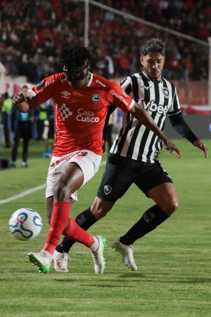 Botafogo's Uruguayan defender #04 Mateo Ponte and Cienciano's Ecuadorean defender #03 Kevin Becerra fight for the ball during the first leg of the Copa Sudamericana round of 16 football match between Peru's Cienciano and Brazil's Botafogo, at the Inca Garcilaso de la Vega stadium in Cusco, Peru, on August 13, 2026. (Photo by Jose Angulo / AFP)