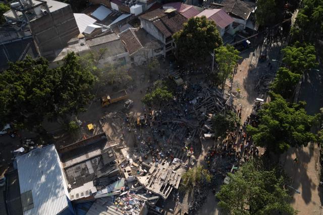This aerial view shows the rubble of a collapsed building in Cali, Colombia, on August 13, 2026, three days after a 7.4-magnitude earthquake. Rescuers in Colombia were making last-ditch efforts to locate earthquake survivors early on August 13, 2026, as the critical 72-hour window for rescue operations neared its end. (Photo by Raul ARBOLEDA / AFP)