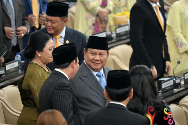 Indonesia's President Prabowo Subianto (C) arrives to deliver his annual State of the Nation Address, ahead of the country's Independence Day celebrations, in Jakarta on August 14, 2026. (Photo by BAY ISMOYO / AFP)