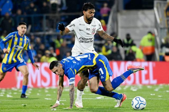 Corinthians' defender #21 Matheus Bidu and Rosario Central's forward #11 Angel Di Maria fight for the ball during the first leg of the Copa Libertadores round of 16 football match between Argentina's Rosario Central and Brazil's Corinthians at the Gigante de Arroyito stadium in Rosario, Santa Fe province, Argentina, on August 13, 2026. (Photo by Marcelo Manera / AFP)