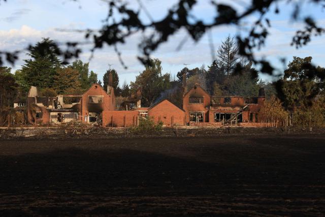 Fire-damaged houses are pictured in Stourbridge, south-west of Birmingham, central England on August 14, 2026. Firefighters continued Friday to extinguish fires that began on August 13, tearing through several homes, with residents evacuated and "extensive" damage reported. (Photo by Darren Staples / AFP)