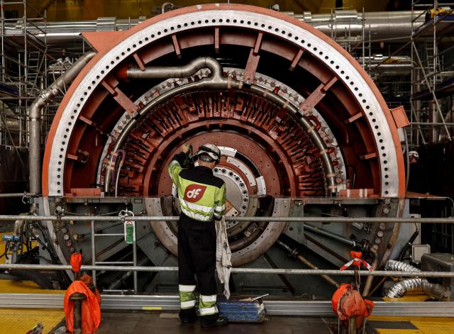 (FILES) A maintenance worker inspects a generator stator during a maintenance outage at the turbine-hall of the Almaraz nuclear power plant in Almaraz, western Spain on April 23, 2026. Spain's socialist government extended the operation of the nuclear power plant of Almaraz, the largest power in Spain, until June 8, 2030, according to an order published on August 14, 2026 in the Official Gazette. (Photo by OSCAR DEL POZO / AFP)