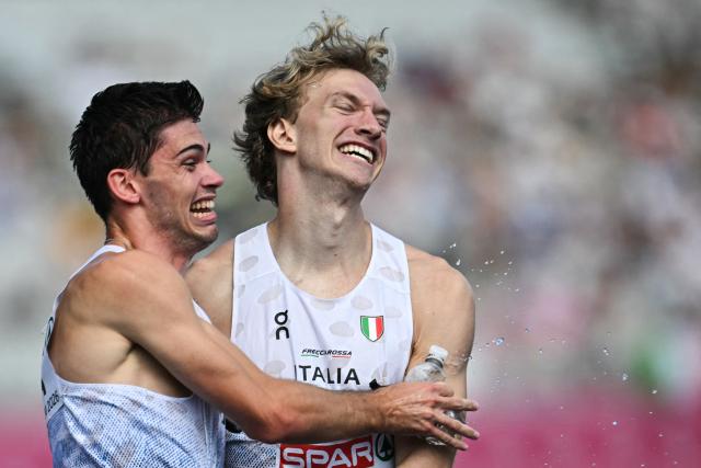 Italy's Luca Sito (L) and Italy's Lorenzo Benati celebrate after arriving first in the men's 4 x 400m relay heats during the European Athletics Championships at Alexander Stadium in Birmingham on August 14, 2026. (Photo by Paul ELLIS / AFP)