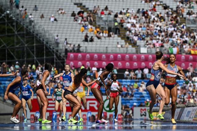Athletes pass the baton as they compete in the women's 4 x 400m relay heat 1 during the European Athletics Championships at Alexander Stadium in Birmingham on August 14, 2026. (Photo by Paul ELLIS / AFP)