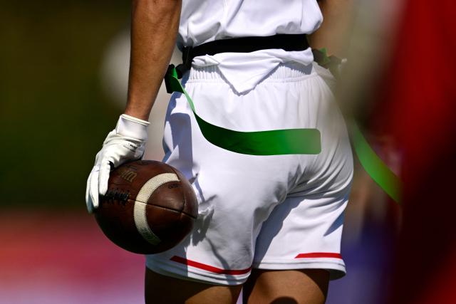 Japan's Tsubasa Brennan carries a ball during the men's match between Austria and Japan at the "IFAF World Flag" World Championship in flag football in Duesseldorf, western Germany, on August 14, 2026. (Photo by Ina FASSBENDER / AFP)