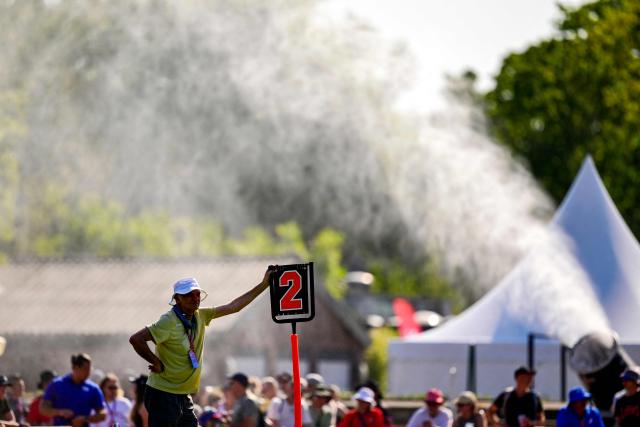 A referee stands in front of a water cannon during the men's match between Austria and Japan at the "IFAF World Flag" World Championship in flag football in Duesseldorf, western Germany, on August 14, 2026. (Photo by Ina FASSBENDER / AFP)
