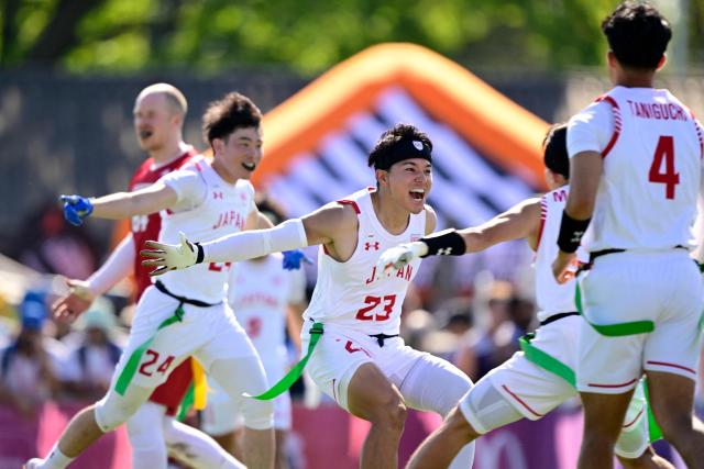 Japan's Ryota Okuda and Japan's Kento Nishida (L) celebrate during the men's match between Austria and Japan at the "IFAF World Flag" World Championship in flag football in Duesseldorf, western Germany, on August 14, 2026. (Photo by Ina FASSBENDER / AFP)