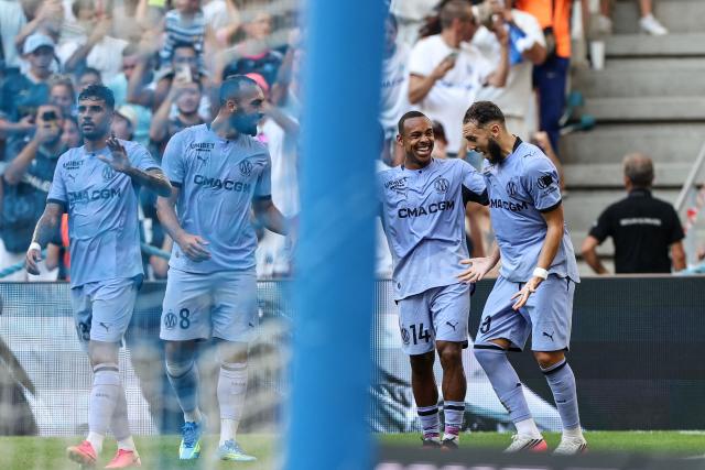 Marseille's Brazilian forward #14 Igor Paixao (2ndR) celebrates with teammates scoring his team's first goal during the pre-season friendly football match between Olympique de Marseille (OM) and Club Atletico de Madrid at Stade Velodrome in Marseille, southern France on August 14, 2026. (Photo by Thibaud MORITZ / AFP)