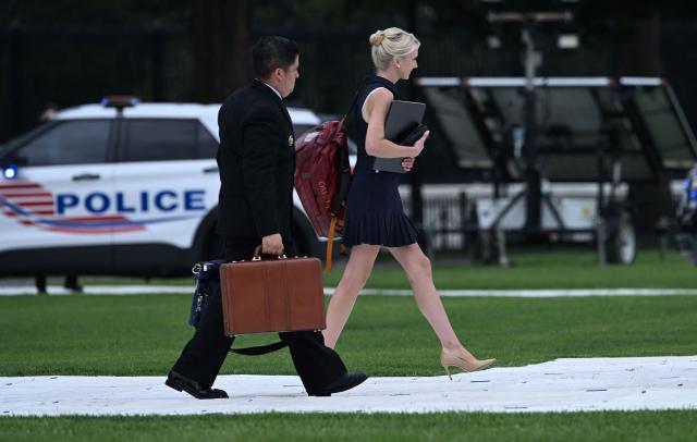US President Donald Trump's aide Natalie Harp walks to board Marine One on the Ellipse near the White House in Washington, DC, on August 14, 2026. Trump is on his way to Garden City, New York, to speak at the Nassau County Police Academy Center for Training and Intelligence before continuing to Bedminster, New Jersey, to spend the weekend at his golf club. (Photo by Brendan SMIALOWSKI / AFP)
