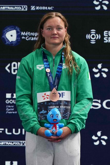 Ireland's Mona Mc Sharry poses with her bronze medal on the podium of the women's 200m breaststroke swimming event during the LEN European Aquatics Championships at the Olympic Aquatic Centre in Saint-Denis, northern suburbs of Paris, on August 14, 2026. (Photo by Dimitar DILKOFF / AFP)