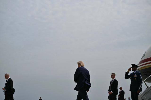 US President Donald Trump steps off Air Force One at John F. Kennedy International Airport in New York on August 14, 2026. Trump is on his way to Garden City, New York to speak at the Nassau County Police Academy Center for Training and Intelligence before continuing to Bedminster, New Jersey, to spend the weekend at his golf club. (Photo by Kent NISHIMURA / AFP)