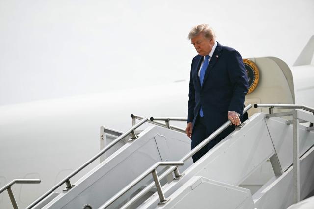 US President Donald Trump steps off Air Force One at John F. Kennedy International Airport in New York on August 14, 2026. Trump is on his way to Garden City, New York, to speak at the Nassau County Police Academy Center for Training and Intelligence before continuing to Bedminster, New Jersey, to spend the weekend at his golf club. (Photo by Kent NISHIMURA / AFP)