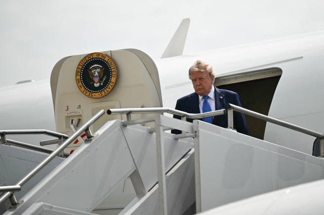 US President Donald Trump steps off Air Force One at John F. Kennedy International Airport in New York on August 14, 2026. Trump is on his way to Garden City, New York, to speak at the Nassau County Police Academy Center for Training and Intelligence before continuing to Bedminster, New Jersey, to spend the weekend at his golf club. (Photo by Kent NISHIMURA / AFP)