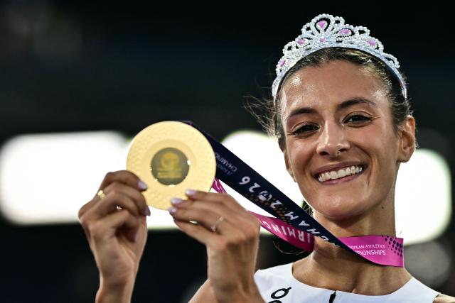 Gold medallist Italy's Nadia Battocletti celebrates after winning the women's 10,000m final during the European Athletics Championships at Alexander Stadium in Birmingham on August 14, 2026. (Photo by Ben STANSALL / AFP)