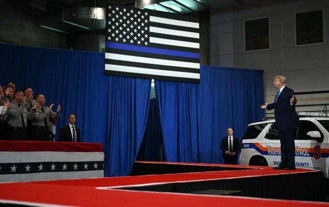 US President Donald Trump arrives to deliver remarks at the Nassau County Police Academy Center for Training and Intelligence in Garden City, New York, on August 14, 2026. (Photo by Kent NISHIMURA / AFP)