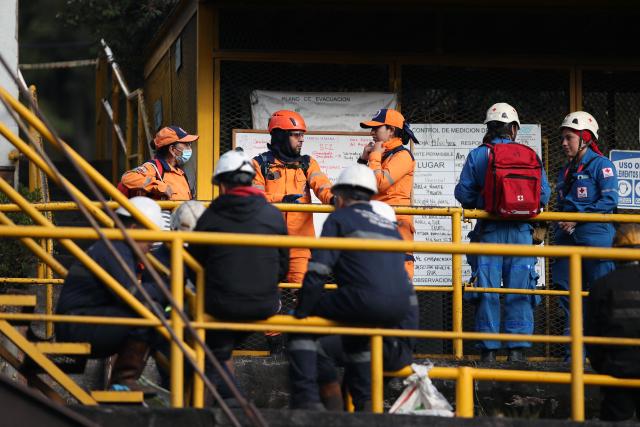 Rescuers, Red Cross members and miners gather outside the El Porvenir 1 mine, where six workers died following an explosion, in La Ramada, Cundinamarca department, Colombia, on August 14, 2026. Six workers at a mine in central Colombia were found dead by rescuers on August 14 after being trapped by an explosion, departmental authorities said. (Photo by ESTEBAN VEGA LA-ROTTA / AFP)