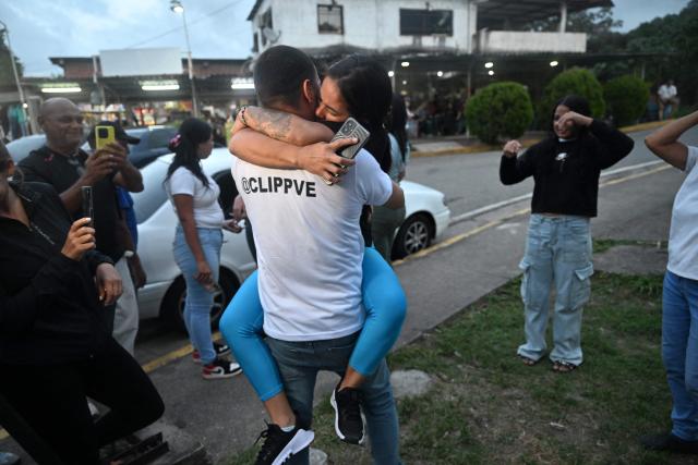 Former political prisoner Angela Vasquez embraces her brother after her release outside El Rodeo I prison in Guatire, Miranda state, Venezuela, on August 14, 2026. Venezuela released 131 political prisoners on August 14, including a woman accused of involvement in an alleged drone attack against ousted leader Nicolas Maduro, following a pledge made the previous day by the opposition representative in talks with the interim government to help secure their release. (Photo by Juan BARRETO / AFP)