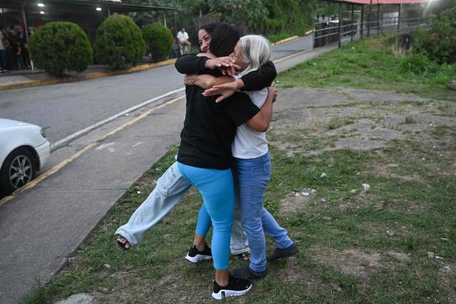 Former political prisoner Angela Vasquez (C) embraces relatives after her release outside El Rodeo I prison in Guatire, Miranda state, Venezuela, on August 14, 2026. Venezuela released 131 political prisoners on August 14, including a woman accused of involvement in an alleged drone attack against ousted leader Nicolas Maduro, following a pledge made the previous day by the opposition representative in talks with the interim government to help secure their release. (Photo by Juan BARRETO / AFP)