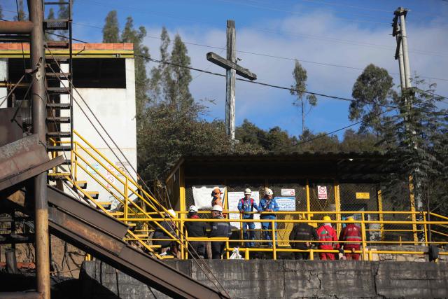Rescuers, Red Cross members and miners gather outside the El Porvenir 1 mine, where six workers died following an explosion, in La Ramada, Cundinamarca department, Colombia, on August 14, 2026. Six workers at a mine in central Colombia were found dead by rescuers on August 14 after being trapped by an explosion, departmental authorities said. (Photo by ESTEBAN VEGA LA-ROTTA / AFP)