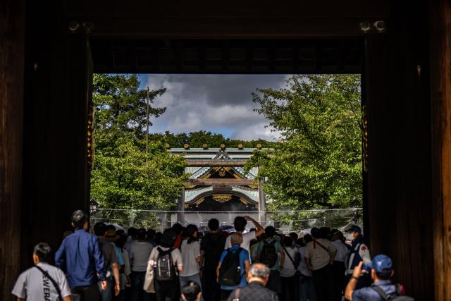 People queue up to pay their respect during a visit to the Yasukuni Shrine in Tokyo on August 15, 2026, on the 81st anniversary of Japan's surrender in World War II. Yasukuni is dedicated to 2.5 million war dead, mostly Japanese, including convicted war criminals involved in Imperial Japan's invasion and occupation of parts of Asia in the 1930s and 1940s. (Photo by Philip FONG / AFP)