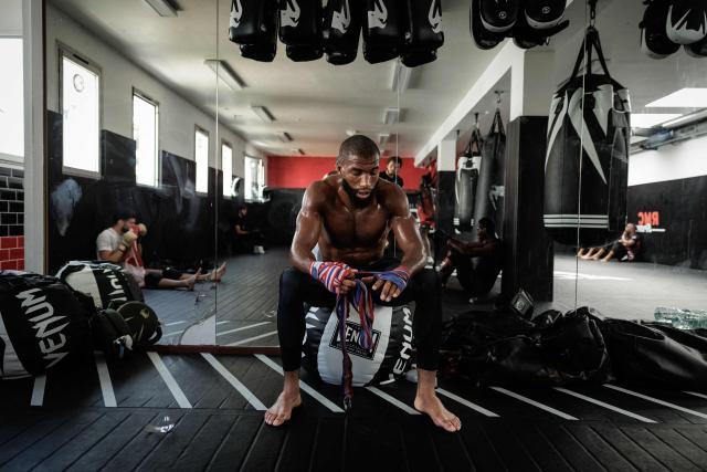 French-Moroccan mixed martial artist Salahdine Parnasse wraps his hands in protection gear during a training session at the Atch Academy training centre in Aubervilliers, a northern Paris suburb on August 13, 2026. For his UFC debut, Salahdine Parnasse is making a grand entrance as the headliner at UFC Paris – a "new beginning" in his career, according to the 28-year-old Frenchman, who is aiming to become the "ultimate fighter". (Photo by SIMON WOHLFAHRT / AFP)